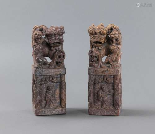 A PAIR OF CARVED SOAPSTONE WEIGHTS WITH LIONS