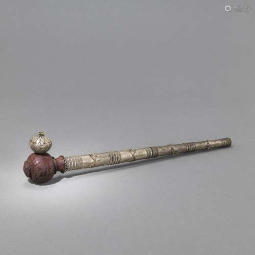 A METAL-FITTED OPIUM PIPE