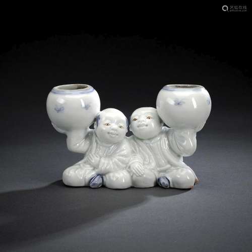 A PAIR OF SEATED HIRADO PORCELAIN BOYS WITH JARS FOR INK