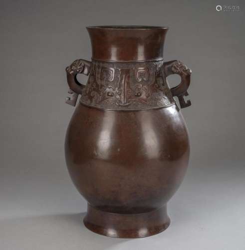 A BRONZE VASE WITH TAOTIE MASKS AND BEAST-SHAPED HANDLES