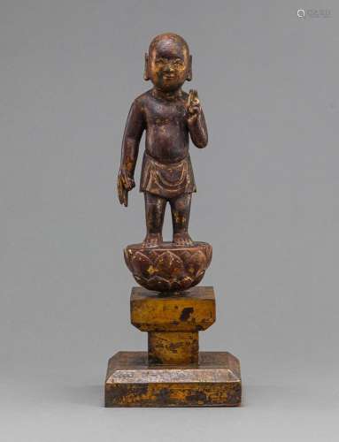 BUDDHA AS A NEWBORN STANDING ON A LOTUS BASE, WOOD WITH GOLD...