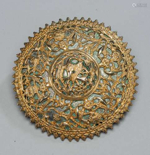 A ROUND METAL ORNAMENT WITH FLOWER AND BIRD DECOR, PARTLY GI...