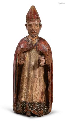 A CARVED POLYCHROME DECORATED FIGURE OF A BISHOP, PROBABLY S...