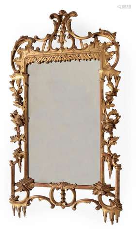 A CARVED GILTWOOD WALL MIRROR, IN IRISH GEORGE II STYLE, SEC...