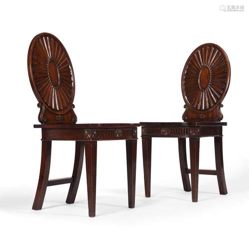 A PAIR OF GEORGE III MAHOGANY HALL CHAIRS, IN THE MANNER OF ...