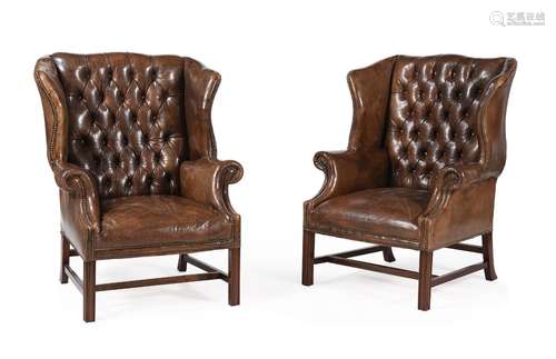 A PAIR OF MAHOGANY AND BUTTONED LEATHER UPHOLSTERED WING ARM...