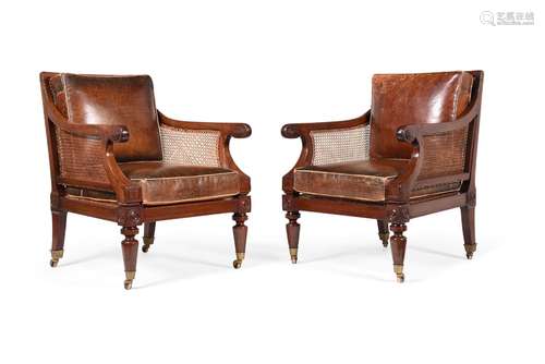 A PAIR OF REGENCY MAHOGANY BERGERE LIBRARY ARMCHAIRS, IN THE...