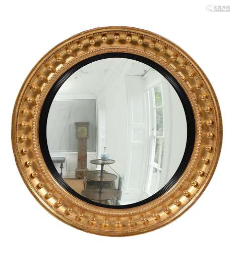 A LARGE REGENCY GILTWOOD AND GESSO CONVEX WALL MIRROR, CIRCA...