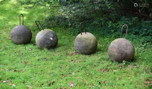 A SET OF FOUR COMPOSITION STONE SPHERES 20TH CENTURY