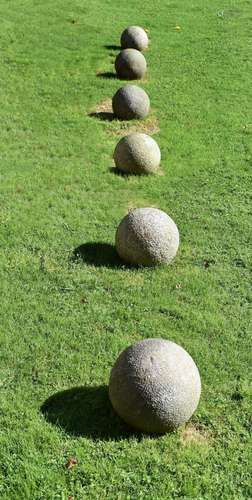 A SET OF SIX CORNISH GRANITE BALLS, PROBABLY EARLY 20TH CENT...