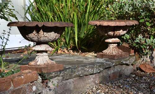 A PAIR OF VICTORIAN CAST IRON TERRACE URNS, IN THE MANNER OF...