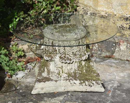 A CARVED LIMESTONE AND GLASS OCCASIONAL TABLE, LATE 19TH/20T...