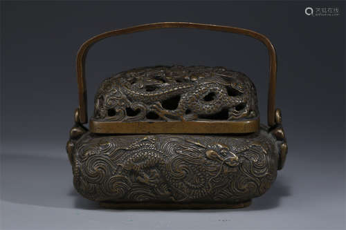 A Copper Handwarmer with Dragon Design.