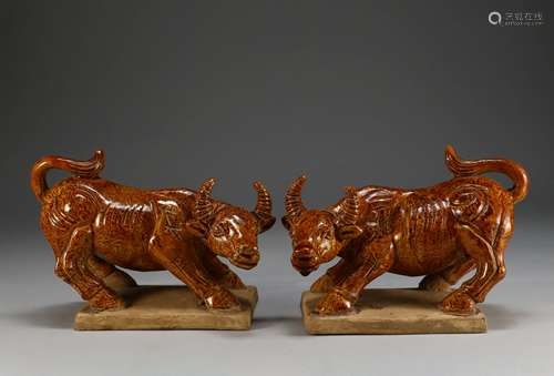 A PAIR OF TANG DYNASTY Twisted yellow glaze double OXES orna...