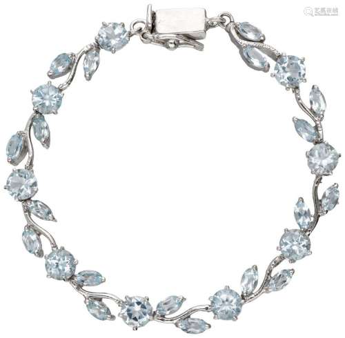 Silver colored bracelet set with blue topaz.