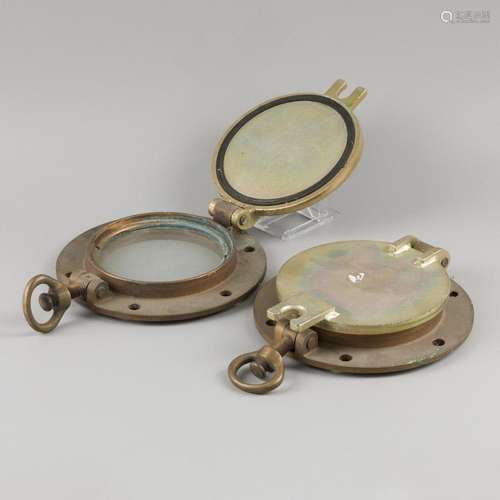 A lot comprising (2) brass port holes/ scuttle ports, 20th c...