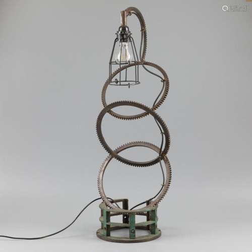 An industrial table lamp, built up from various machine part...