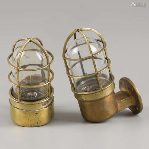 A lot comprising (2) various brass stormlamps/ cage lamps, 2...