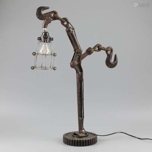 An industrial table lamp, built up from various machine part...