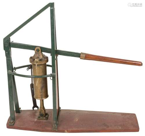 A large green laquered steel bilge pump with copper cylinder...
