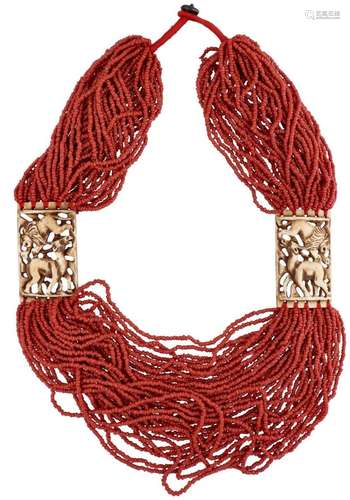 Blood coral necklace with a depiction of a lion and antelope...