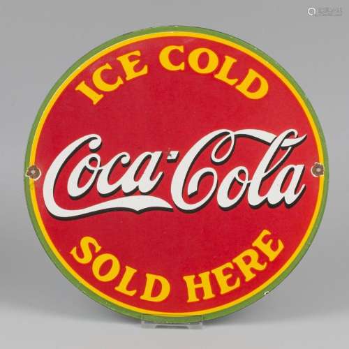 An enamel advertising board with a picture of Coca-Cola. Mid...