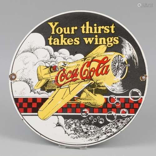 An enamel advertising board with a picture of Coca-Cola. Mid...