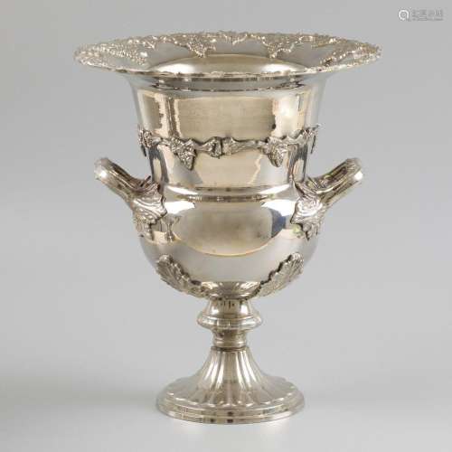 A silver-plated champagne cooler with two handles and decora...
