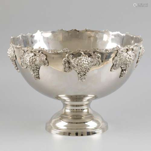 A silver-plated champagne cooler decorated with bunches of g...