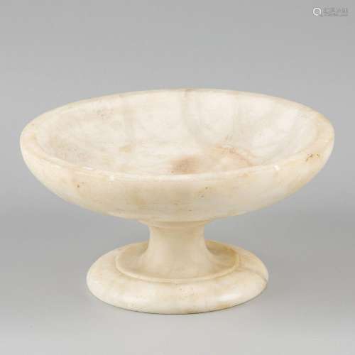 A marble fruit bowl on stand.