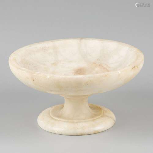 A marble fruit bowl on stand.