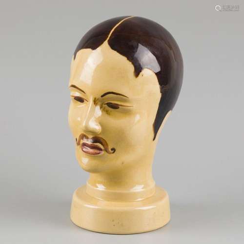 An art deco barber style hat stand in the shape of a mens he...