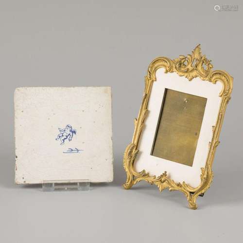 A bronze gilded photo frame in Louis the 15th style with an ...