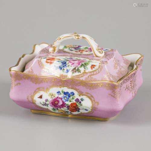A porcelain (soap) lidded box decorated with flowers, marked...