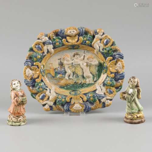 A majolica charger with scene of putti playing with a goat, ...