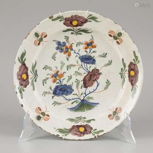 An earthenware dish with polychrome decor of flowers. Delft,...