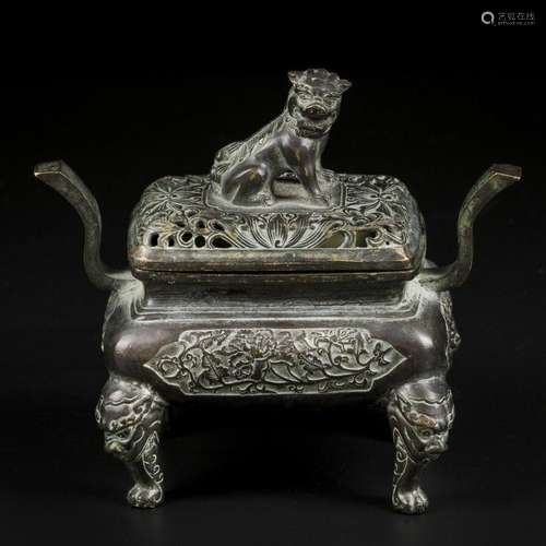 A bronze incense burner decorated with foo-dog on the lid. C...