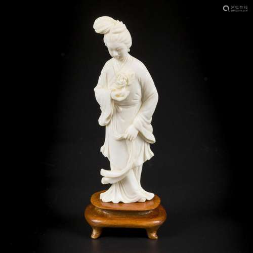 An ivory Chinese lady with a flower in her hand. China, circ...