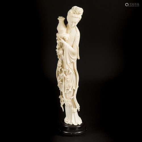 An ivory-sculpted Guan-Yin on a wooden base. China, circa 19...