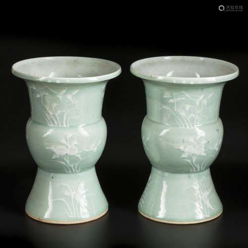 A set of two caldonaria cachepots decorated with plants. Chi...