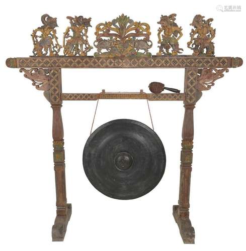 A large carved Indonesian gong with Wajang carvings.