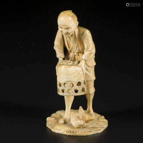 An ivory okimono depicting a man with his chickens, Japan, M...