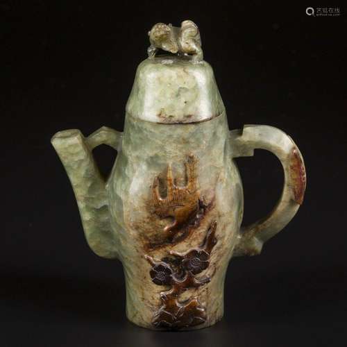 A Celadon jade teapot decorated with a lion as lid knob and ...