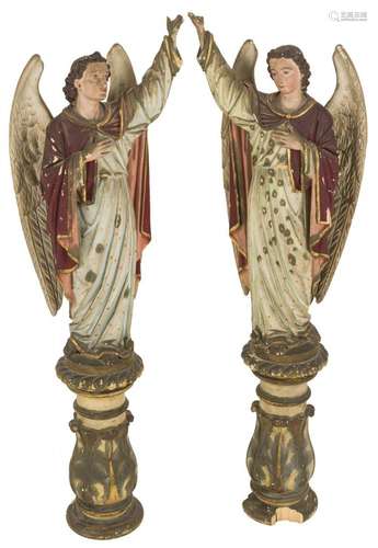 A pair of polychrome sculptures of angels.