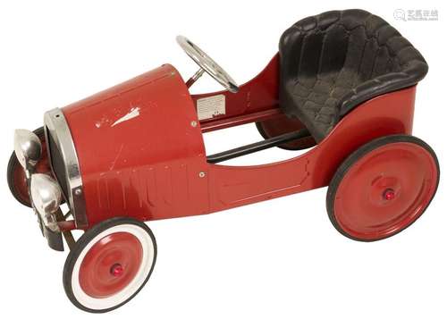 A red laquered pedal car.