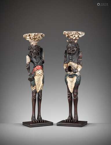 A PAIR OF PAINTED AND LACQUERED WOOD FIGURAL CANDLESTICKS DE...