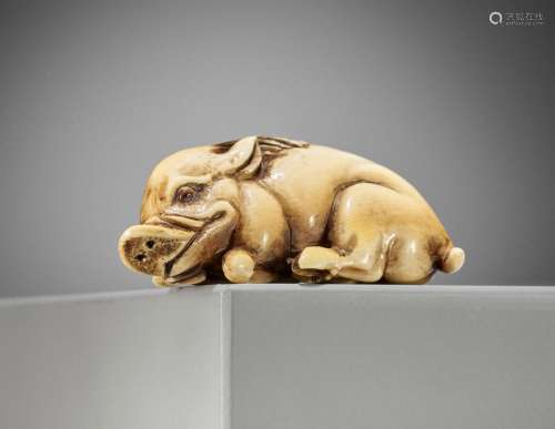 MASATSUGU: A FINE IVORY NETSUKE OF A RECUMBENT BOAR