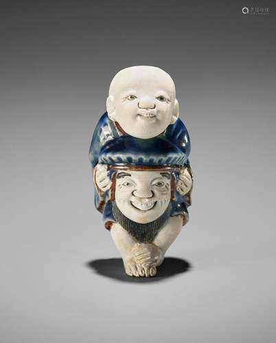 A LARGE HIRADO PORCELAIN NETSUKE OF A BOY WITH DAIKOKU MASK