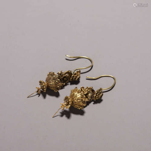 A pair of golden basket earrings