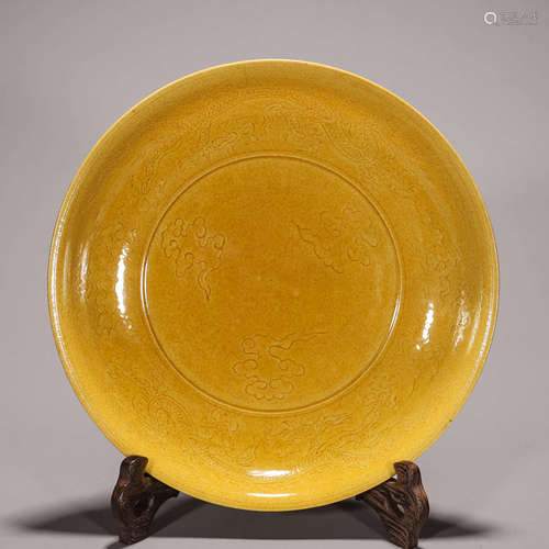 A yellow glazed dragon carved porcelain plate